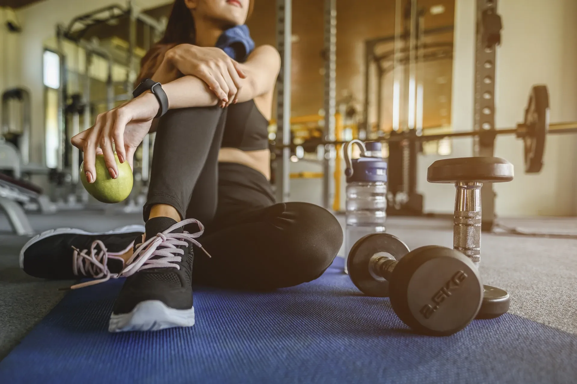 A resident cools off after a workout with free weights in a fully equipped fitness center